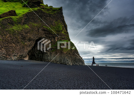 Halsanefshellir cave with Reynisdrangar natural rock formation on Reynisfjara black sand beach in gloomy day at Iceland Halsanefshellir cave with Reynisdrangar natural rock formation on Reynisfjara black sand beach in gloomy day at Iceland 108471642
