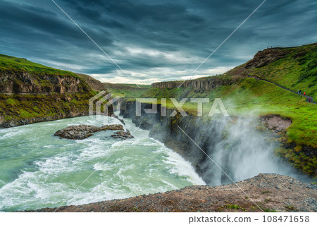 Gullfoss powerful waterfall flowing from Hvita river and moody sky in summer at Iceland Gullfoss powerful waterfall flowing from Hvita river and moody sky in summer at Iceland 108471658
