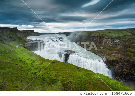 Gullfoss powerful waterfall flowing from Hvita river and moody sky in summer at Iceland Gullfoss powerful waterfall flowing from Hvita river and moody sky in summer at Iceland 108471660