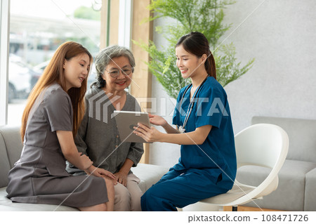 Asian doctor woman visited patient elder woman to diagnosis and check up health at home or private hospital. Female patient looking Medical Checkup Course for elderly health care at premium clinic. 108471726