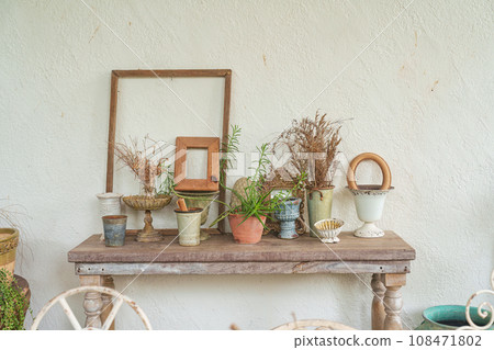 Vintage antique object collection with vase, frame on wooden table in living room Vintage antique object collection with vase, frame on wooden table in living room 108471802