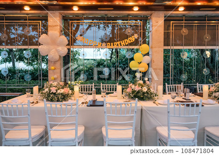 Setting up a banquet dining table for a birthday celebration, decor in restaurant 108471804