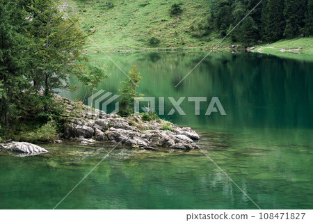 Seealpsee mountain lake reflection in Alpstein mountain range during summer at Appenzell, Switzerland 108471827