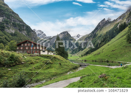Seealpsee mountain lake with hotel on hill in Alpstein mountain range during summer at Appenzell, Switzerland 108471829