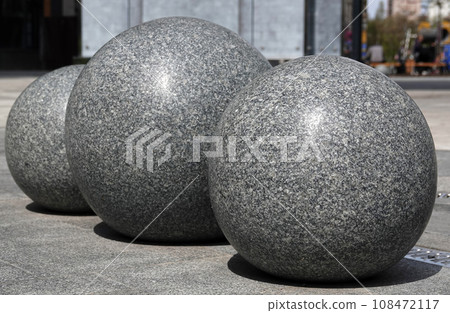 Kiev, Ukraine May 1, 2021: Three marble balls decoration of a residential quarter in the Pechersky district of Kiev with a monument stylized as the Arc de Triomphe in Paris Kiev, Ukraine May 1, 2021: Three marble balls decoration of a residential quarter in the Pechersky district of Kiev with a monument stylized as the Arc de Triomphe in Paris 108472117