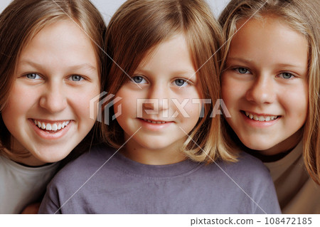 Faces of three girls in a row in casual clothes 108472185