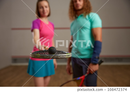 Happy couple posing for camera after squash game 108472374