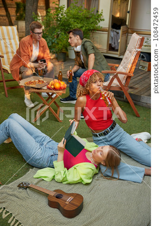 Millennial people, group of friends enjoy picnic and travelling with camper van Millennial people, group of friends enjoy picnic and travelling with camper van 108472459