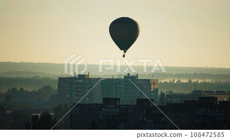 Kiev, Ukraine June 30, 2021: Hot air balloon early in the morning over residential buildings in the city of Kiev Kiev, Ukraine June 30, 2021: Hot air balloon early in the morning over residential buildings in the city of Kiev 108472585