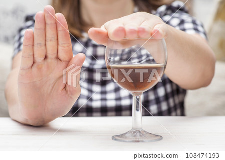 Young woman refused alcohol drink. Concept of alcoholism. Womans alcoholism Young woman refused alcohol drink. Concept of alcoholism. Womans alcoholism 108474193