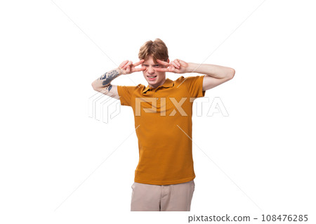 portrait of a young adorable redhead man dressed in a yellow t-shirt on a white background with copy portrait of a young adorable redhead man dressed in a yellow t-shirt on a white background with copy 108476285
