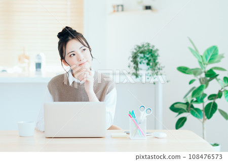 A young woman doing telework in the living room. A young woman doing telework in the living room. 108476573
