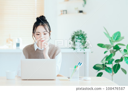 做遠程辦公的一個少婦在客廳。 做遠程辦公的一個少婦在客廳。 108476587