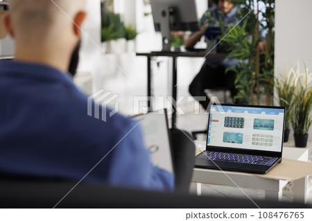 Businessman monitoring fund and stock exchange investments on laptop screen while working in business office. Executive manager studying market trends and financial data in coworking space Businessman monitoring fund and stock exchange investments on laptop screen while working in business office. Executive manager studying market trends and financial data in coworking space 108476765