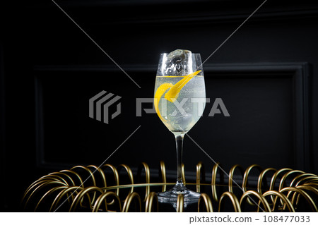 side view of transparent cocktail with ice on a dark background side view of transparent cocktail with ice on a dark background 108477033