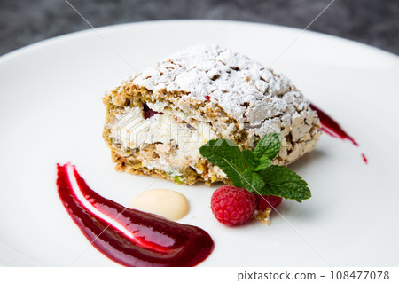 sweet sponge dessert with raspberries and powdered sugar side view sweet sponge dessert with raspberries and powdered sugar side view 108477078