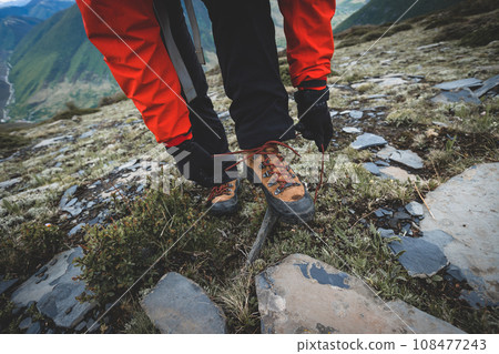 Hiking woman on high altitude mountain top Hiking woman on high altitude mountain top 108477243