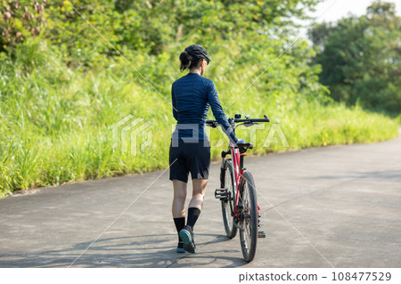 Riding bike in spring forest 108477529
