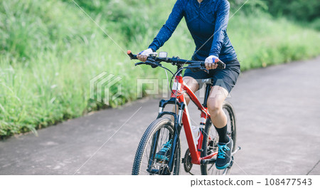 Riding bike in spring forest Riding bike in spring forest 108477543