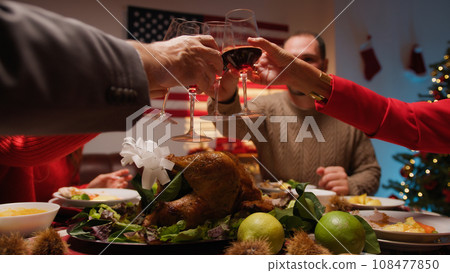 cheering and drinking wine to celebrate thanksgiving cheering and drinking wine to celebrate thanksgiving 108477850