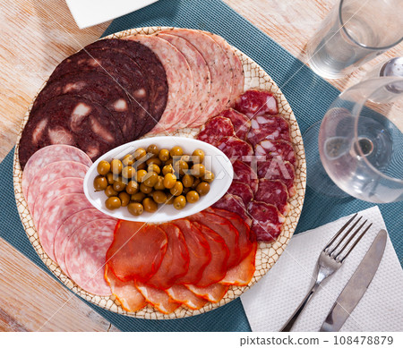 Cold cuts from sausages, cured pork loin with olives 108478879