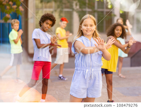 Group of kids performing street dance outdoors Group of kids performing street dance outdoors 108479276