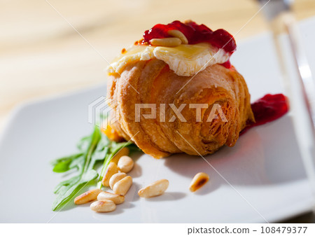 Croissant with camembert, jam and pine nuts Croissant with camembert, jam and pine nuts 108479377