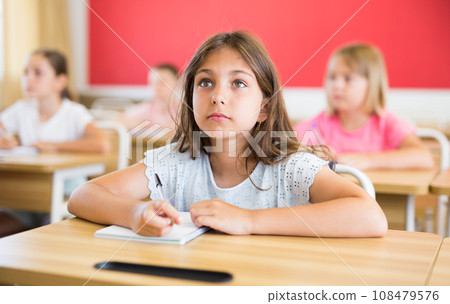 Girl sitting in classroom Girl sitting in classroom 108479576