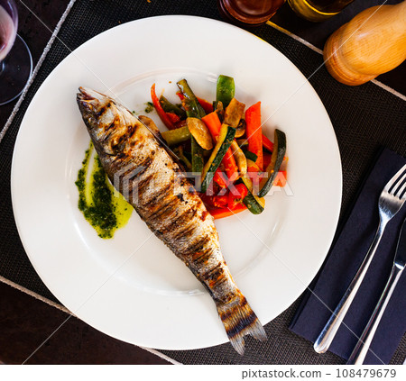 Grilled sea bass with grilled zucchini, pepper and mushrooms 108479679