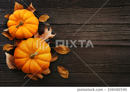 Autumn pumkins and colorful leaves composition, fall leaf frame, Thanksgiving festive background, selective focus 108480590