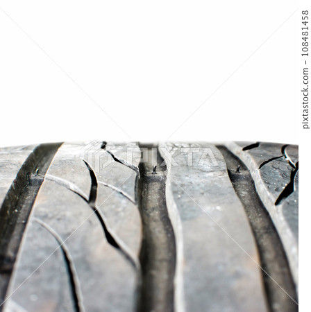 Tire tread wear indicator showing on tread grooves on white background , Automotive parts concept 108481458