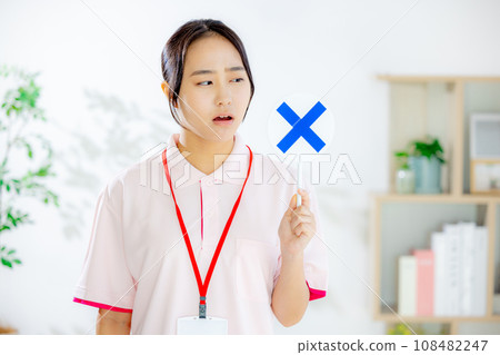 A woman holding a cross-marked plate 108482247