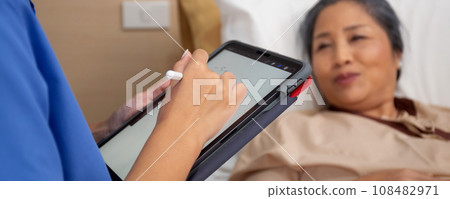 Closeup hands nurse writing report document about prescribe medical and health care on tablet. Closeup hands nurse writing report document about prescribe medical and health care on tablet. 108482971