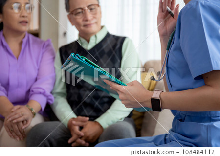 Caregiver sitting on sofa checkup and diagnostic with elderly couple patient about health. Caregiver sitting on sofa checkup and diagnostic with elderly couple patient about health. 108484112