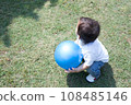 toddler playing with blue ball 108485146