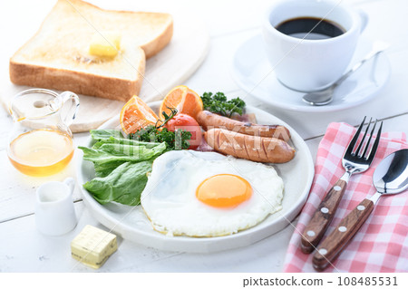 Breakfast of fried egg, salad, bread and coffee Breakfast image 108485531