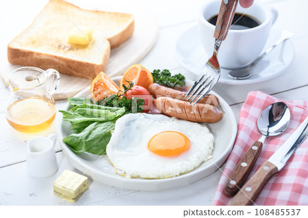 Breakfast of fried egg, salad, bread and coffee Breakfast image 108485537