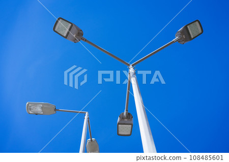 street lamps on a pole against the sky 108485601