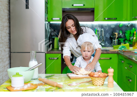 happy mother and son in the kitchen and making dough, family cooking concept 108485967