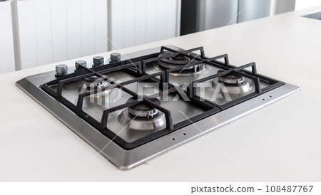 Modern hob gas stove countertop in big kitchen interior. Modern hob gas stove countertop in big kitchen interior. 108487767