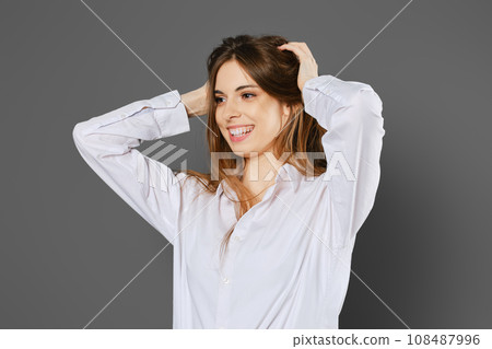 Happy woman clutching her head 108487996