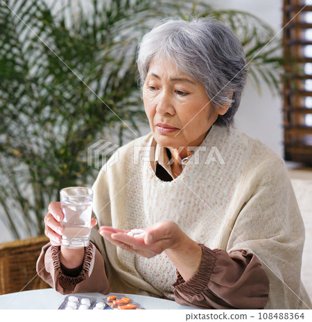 "AI-generated image" of an elderly woman drinking medicine with an anxious expression 108488364