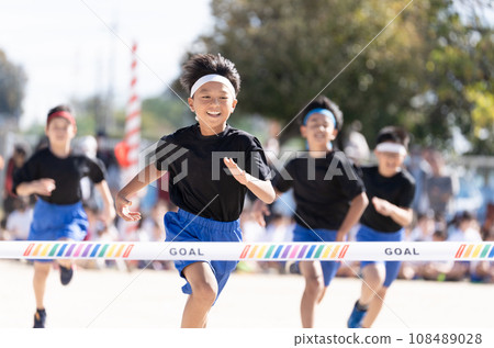 Elementary school boy who wins the first prize in a foot race Elementary school boy who wins the first prize in a foot race 108489028