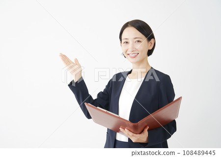 Business woman giving a presentation with a file, white background, looking at camera Business woman giving a presentation with a file, white background, looking at camera 108489445