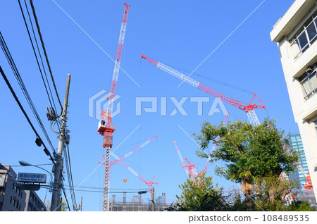 A view of a large crane at a construction site in Tokyo A view of a large crane at a construction site in Tokyo 108489535