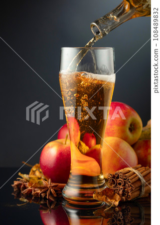 Apple cider is poured in high glass. 108489832