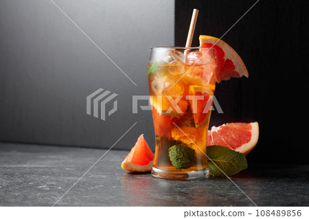 Iced tea or a summer refreshing drink with ice, mint, and grapefruit. Iced tea or a summer refreshing drink with ice, mint, and grapefruit. 108489856