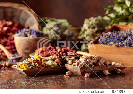 Various dried medicinal plants on a brown background. Various dried medicinal plants on a brown background. 108489864
