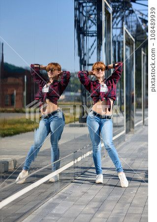 Close-up Portrait of Stylish Redhead Woman in Urban Autumn Fashion 108489939