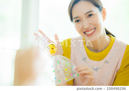 Nursery teacher making teruteru bozu at nursery school 108490206